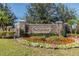 Stone Ballentrae community sign with landscaped flowerbeds and American flags at 11837 Thicket Wood Dr, Riverview, FL 33579