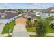 Well-maintained home featuring a two-car garage, lush landscaping, and a manicured lawn at 11837 Thicket Wood Dr, Riverview, FL 33579