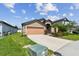 Charming single-Gathering home featuring a two-car garage and beautifully landscaped front yard at 11837 Thicket Wood Dr, Riverview, FL 33579