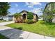 Beautiful single-Gathering home featuring a well-kept lawn and colorful tropical landscaping at 11837 Thicket Wood Dr, Riverview, FL 33579