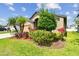 Charming single-Gathering home featuring a beautifully landscaped front yard with lush greenery at 11837 Thicket Wood Dr, Riverview, FL 33579