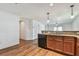 View of kitchen cabinets, dishwasher and sink overlooking an adjacent room at 11837 Thicket Wood Dr, Riverview, FL 33579