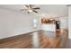 A modern living room features sleek wood-look flooring, and an open concept kitchen at 11837 Thicket Wood Dr, Riverview, FL 33579