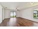 Bright living room with wood floors and sliding glass doors to the backyard at 11837 Thicket Wood Dr, Riverview, FL 33579