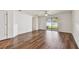 Open living room with wood floors, sliding glass doors, and plenty of natural light at 11837 Thicket Wood Dr, Riverview, FL 33579