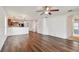 Inviting open-concept living space with wood floors and a modern ceiling fan at 11837 Thicket Wood Dr, Riverview, FL 33579