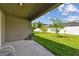 View of the patio area overlooking the green backyard and white fence at 11837 Thicket Wood Dr, Riverview, FL 33579