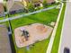 Aerial view of a community playground featuring swings, slides, and play equipment for children at 11837 Thicket Wood Dr, Riverview, FL 33579