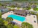 Community pool and lounge area surrounded by lush landscaping and seating at 11837 Thicket Wood Dr, Riverview, FL 33579