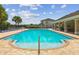 Inviting community pool with clear blue water, brick surround, and comfortable lounge seating at 11837 Thicket Wood Dr, Riverview, FL 33579