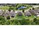 Aerial view of a well-maintained property with a spacious backyard, situated near a scenic pond at 12316 Streambed Dr, Riverview, FL 33579