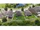 Aerial view showcasing a large backyard with playset, bordering a pond in a serene neighborhood at 12316 Streambed Dr, Riverview, FL 33579