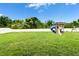 Spacious backyard featuring a large green lawn and a playset with slide and swings at 12316 Streambed Dr, Riverview, FL 33579