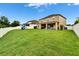 A spacious backyard includes an outdoor seating area and a white fence providing privacy at 12316 Streambed Dr, Riverview, FL 33579