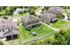 Aerial view of a spacious backyard featuring a well-maintained lawn, white fence and a play structure at 12316 Streambed Dr, Riverview, FL 33579