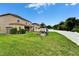 Expansive backyard features a playset, lush lawn, white fence, and covered patio, ideal for entertaining at 12316 Streambed Dr, Riverview, FL 33579