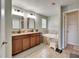 Primary bathroom with dual sinks, vanity, jacuzzi tub, and large mirrors at 12316 Streambed Dr, Riverview, FL 33579