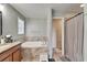 Bathroom featuring a soaking tub, dual-sink vanity, and separate shower room at 12316 Streambed Dr, Riverview, FL 33579