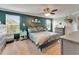 Primary bedroom with a king bed, ceiling fan, and two large windows at 12316 Streambed Dr, Riverview, FL 33579
