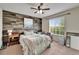 Bedroom featuring wood accent wall, a queen bed, and a window at 12316 Streambed Dr, Riverview, FL 33579