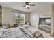 This bedroom has a ceiling fan, a window, a closet, and a decorative mirror at 12316 Streambed Dr, Riverview, FL 33579