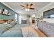 Primary bedroom with a king bed, ceiling fan, and a partial view into the bathroom at 12316 Streambed Dr, Riverview, FL 33579