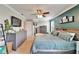 Large primary bedroom with a king bed, ceiling fan, tv, and two dressers at 12316 Streambed Dr, Riverview, FL 33579