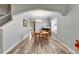 Formal dining room featuring wood-look floors, arched entryway, and bright natural light at 12316 Streambed Dr, Riverview, FL 33579