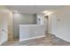 Second floor hallway with wood-look floors, leading to bedrooms and bathrooms at 12316 Streambed Dr, Riverview, FL 33579