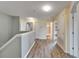 Upstairs hallway with wood-look floors, linen closet, and access to the bedrooms and bathroom at 12316 Streambed Dr, Riverview, FL 33579