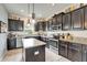 Traditional kitchen featuring a center island, granite countertops, stainless steel appliances, and tile floors at 12316 Streambed Dr, Riverview, FL 33579