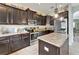 Traditional kitchen with dark cabinets, stainless steel appliances, a center island and granite countertops at 12316 Streambed Dr, Riverview, FL 33579