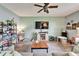 Inviting living room featuring wood floors, a ceiling fan, a large window, and neutral paint colors at 12316 Streambed Dr, Riverview, FL 33579