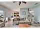 Comfortable living room with a gray couch, light blue walls and an open view to the kitchen at 12316 Streambed Dr, Riverview, FL 33579