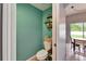 A compact powder room with an accent wall and a decorative shelf at 12316 Streambed Dr, Riverview, FL 33579