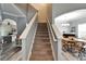 Carpeted staircase leading to the second floor, adjacent to dining area and living room at 12316 Streambed Dr, Riverview, FL 33579