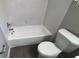 Cozy bathroom featuring a tub and tiled wall at 12804 Millridge Forest St, Tampa, FL 33624