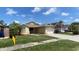Lovely single-Gathering home boasting a lush green lawn and attached one car garage at 12804 Millridge Forest St, Tampa, FL 33624