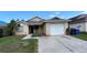 Charming single Gathering home with attached garage and well-manicured front lawn at 12804 Millridge Forest St, Tampa, FL 33624