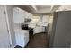 The remodeled kitchen is equipped with stainless steel appliances and white cabinets at 12804 Millridge Forest St, Tampa, FL 33624