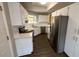 Bright kitchen features white cabinets, stainless steel appliances, and dark hardwood floors at 12804 Millridge Forest St, Tampa, FL 33624