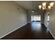 Spacious living room with dark hardwood floors and sliding glass doors leading to the porch at 12804 Millridge Forest St, Tampa, FL 33624