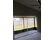 Cozy patio with gray carpeted floors and a fan overlooks the fenced backyard at 12804 Millridge Forest St, Tampa, FL 33624