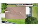 Overhead aerial view of the brown roof with backyard lanai and green lawn at 13910 Chalk Hill Pl, Riverview, FL 33579