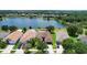 Aerial view of home showcasing roof, lawn, landscaping and water view at 13910 Chalk Hill Pl, Riverview, FL 33579