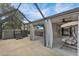 Spacious backyard with a screened patio, including a hot tub, outdoor kitchen, and waterfront views at 13910 Chalk Hill Pl, Riverview, FL 33579