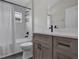 Clean, renovated bathroom featuring a shower-tub combo with a modern vanity and fixtures at 13910 Chalk Hill Pl, Riverview, FL 33579