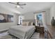 Bright bedroom featuring a king bed, ceiling fan and views of the surrounding landscape at 13910 Chalk Hill Pl, Riverview, FL 33579