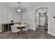 Cozy dining room features a modern light fixture, grey wood floors and a stylish marble table with seating for four at 13910 Chalk Hill Pl, Riverview, FL 33579