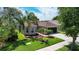 Charming home featuring lush landscaping, a well-manicured lawn, and a welcoming facade at 13910 Chalk Hill Pl, Riverview, FL 33579